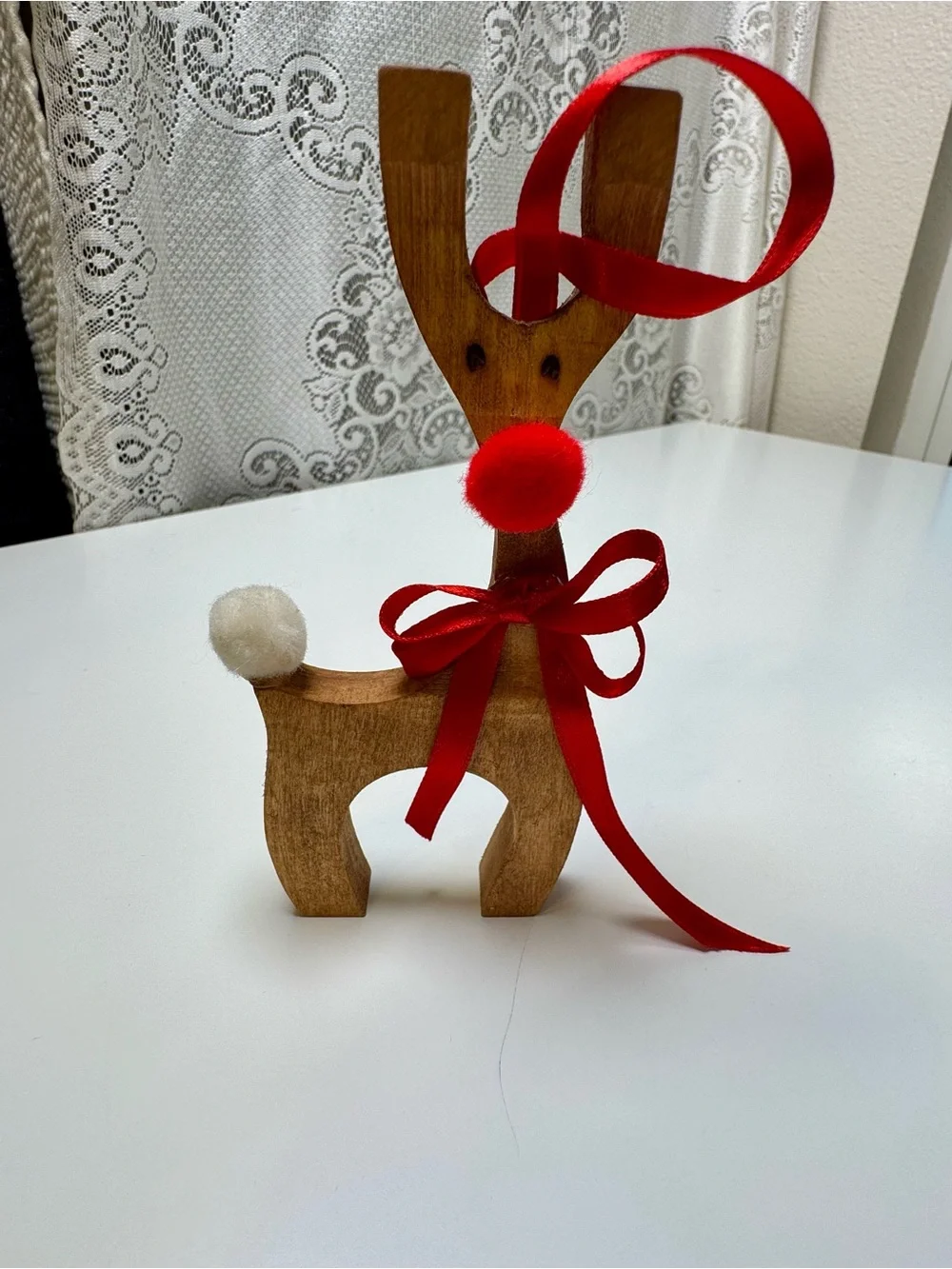 Homemade Wooden Reindeer Holiday Décor with Red Ribbon and Pom-Poms
